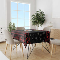 Black rectangular Christmas tablecloth with reindeer and snowflake pattern, red accents.