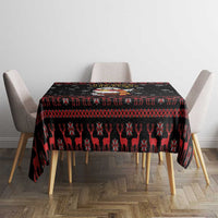 Black Christmas tablecloth with reindeer and snowflake pattern, red band across the table.