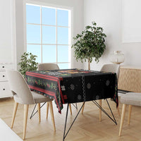 Black tablecloth with colorful holiday border, cats and dogs; drapes over dining table