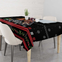 Black tablecloth corner with red striped trim and green leaf pattern, cats and dogs