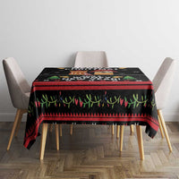 Black holiday tablecloth with cat and dog scenes, red stripe and green grass pattern