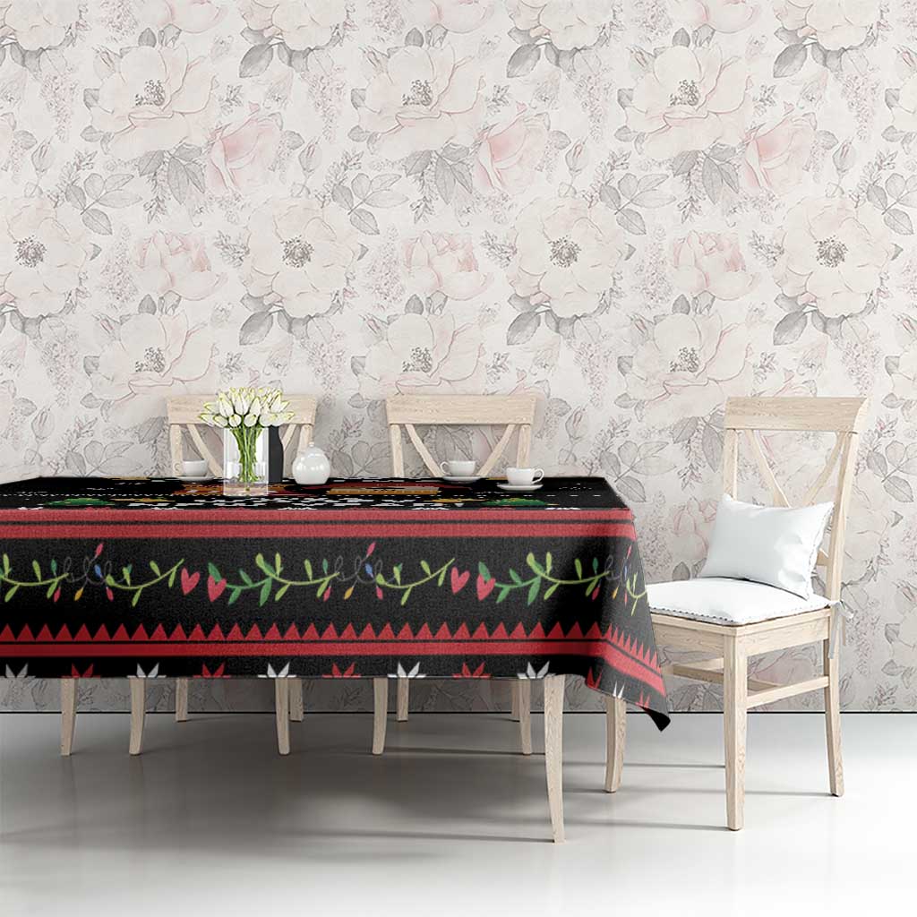 Black tablecloth with colorful holiday border and cat-and-dog graphics on dining table