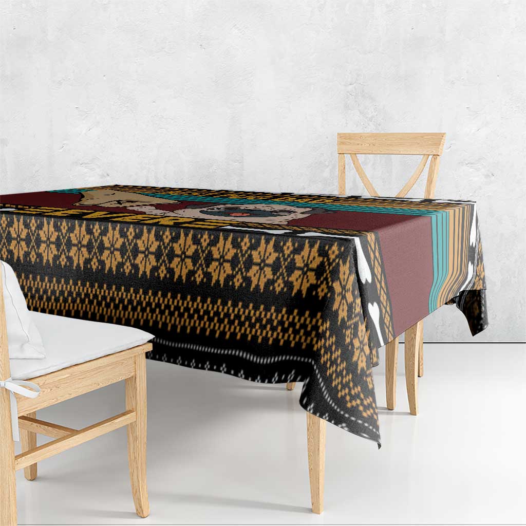 Pug-themed tablecloth shown from the side, hanging over wood dining table edge