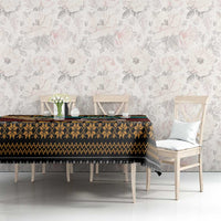 Pug-themed tablecloth on long dining table with black, tan, and teal stripe pattern