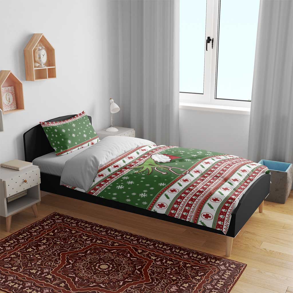 Green holiday bedding set on bed with duvet cover and pillowcases; snowflakes and red crosses