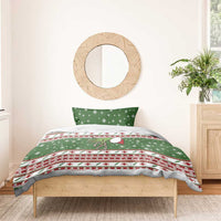 Green holiday duvet and pillowcases with snowflakes, red cross icons, and striped trim