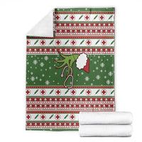 Folded green Christmas blanket set, red-and-white cross stripes with stethoscope and snowflakes.