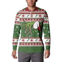 Green nurse-themed Christmas sweatshirt on model, red collar and long sleeves with medical pattern