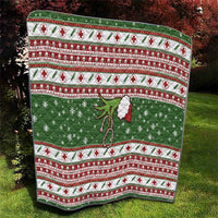 Green Christmas quilt with red-and-white stripes, snowflake motifs, and hanging white flower