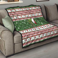 Green holiday quilt draped over sofa with red-and-white border, snowflakes, and medical cross icons