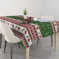 Green Christmas tablecloth draped over dining table, medical-cross and holiday pattern