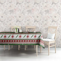 Green Christmas tablecloth on dining table with red medical-cross holiday pattern