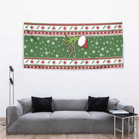 Green Christmas nurse-themed tapestry wall hanging centered above a gray sofa