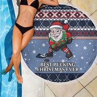 Blue round beach blanket with fringe, Santa hockey graphic and scattered snowflakes