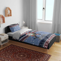 Blue Christmas duvet and pillow shams with hockey Santa elf and festive geometric trim.