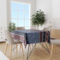 Navy blue Santa hockey Christmas tablecloth with red and white patterned trim on dining table