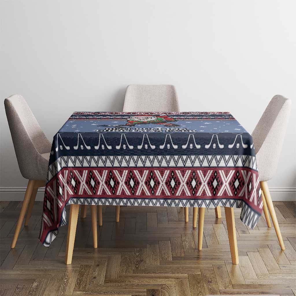Navy blue Christmas tablecloth with red and white patterned band across top, on dining table