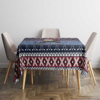 Navy blue Christmas tablecloth with red and white patterned band across top, on dining table