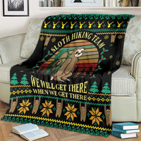 Black sloth hiking team blanket draped on sofa, featuring sloth characters and gold text