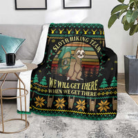 Black sloth hiking team blanket on chair, with green trees and yellow snowflake edging