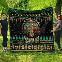 Black quilt blanket with holiday border of trees and walkers; central sloth graphic