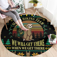 Round black sloth hiking team rug with central sloth and backpack graphic and slogan text