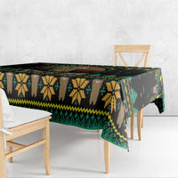 Black tablecloth edge view with green and yellow geometric patterns and forest icons