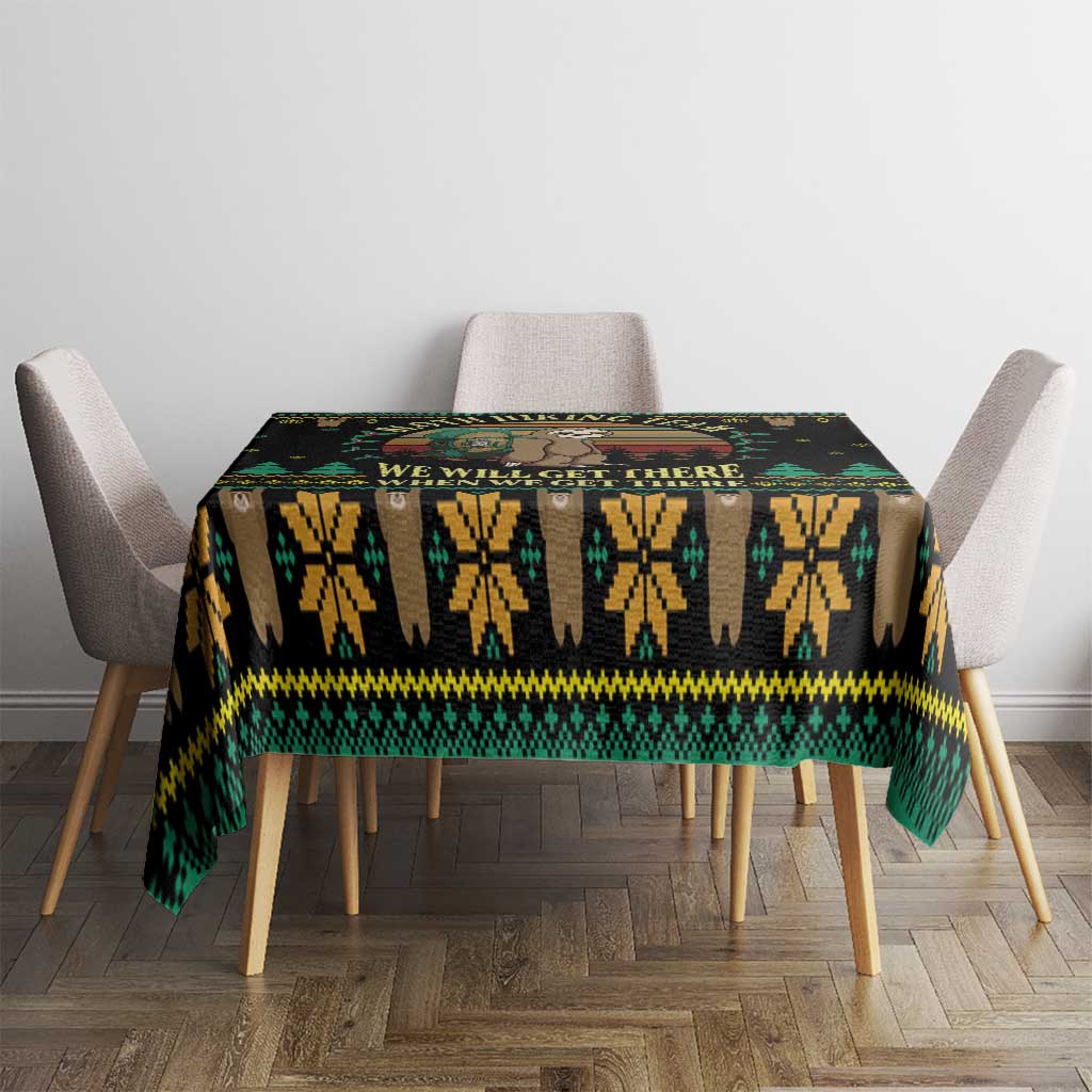 Black tablecloth with green and yellow zigzag motif and We will get there text