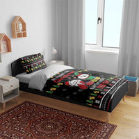 Black Christmas bedding set on bed with duvet and two patterned throw pillows