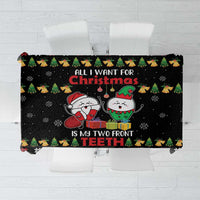 Black holiday tablecloth with cartoon elves and bold red text, plus festive icon border