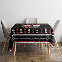 Black holiday tablecloth with striped snowflake band design on a dining table