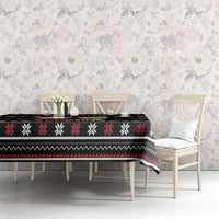Black holiday tablecloth with snowflake stripe pattern and festive border on dining set