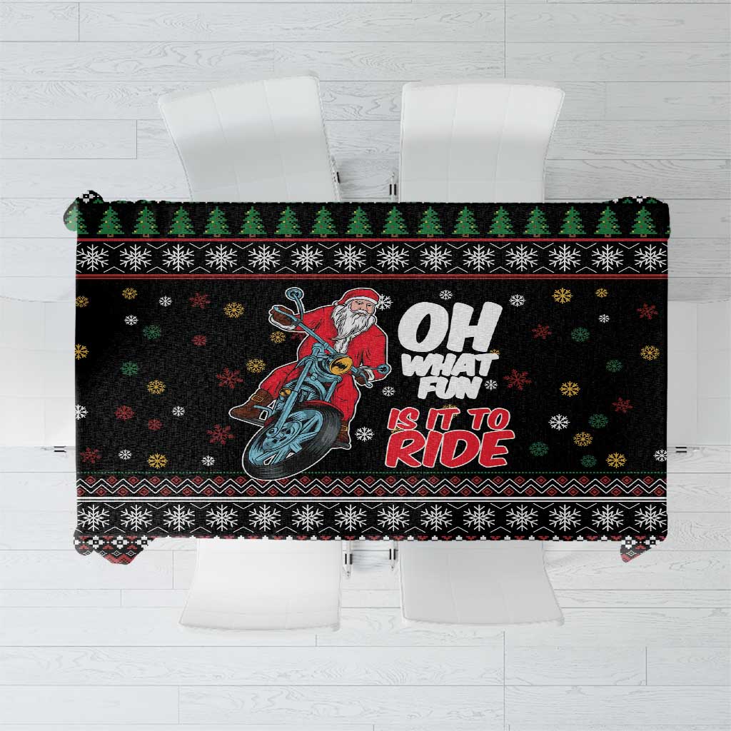 Black holiday tablecloth with Santa on motorcycle, snowflake and border patterns