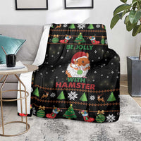 Black holiday hamster blanket on gray couch with evergreen trees, stockings, and snowflakes