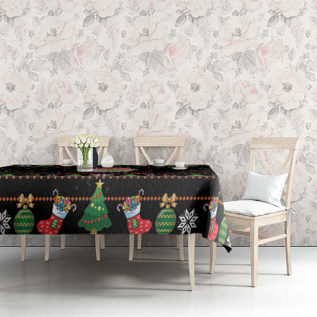 Black holiday tablecloth with colorful trees, socks, and festive icon pattern