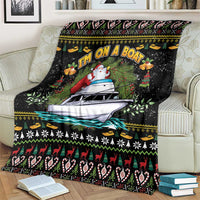 Black blanket with large boat-and-Santa scene and winter pattern stripes at bottom