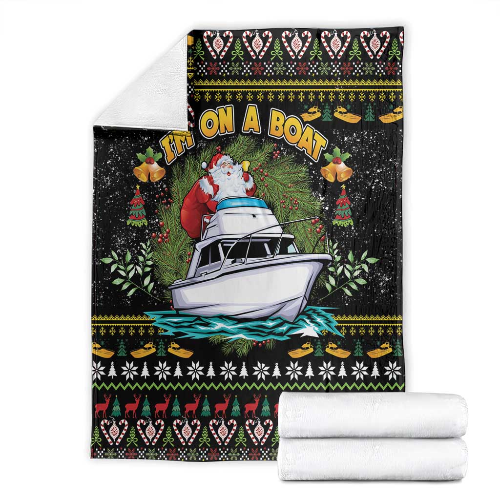 Black blanket laid flat with Santa on a boat and Christmas patterned bands