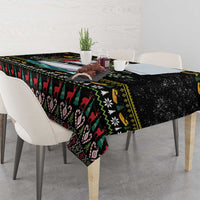 Black Christmas tablecloth with Santa boat center graphic and holiday edge pattern