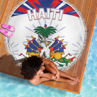 White round beach blanket with fringed edge, HAITI title and central crest graphic.
