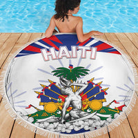 Round white beach blanket with fringed border, HAITI lettering and palm-and-crest artwork.