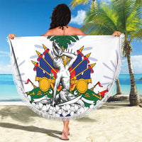 White round beach blanket with fringed edge, HAITI design and seated statue crest artwork.