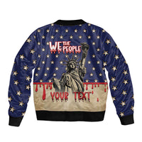 Blue bomber jacket with star pattern, We The People Statue of Liberty graphic, red drips, cuffs