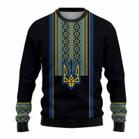 Black knitted sweatshirt with blue-yellow folk panel and trident emblem on front.
