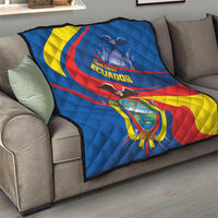 Ecuador flag quilt on living room sofa, blue, yellow, and red design with crest