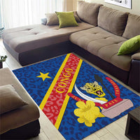 Blue area rug with CONGO lettering, leopard face, star and red PAIX TRAVAIL stripe