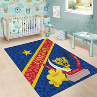 Blue area rug featuring leopard emblem, yellow flower, star, and CONGO PAIX TRAVAIL text