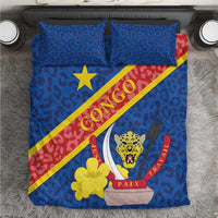 Blue bedding set flat lay: leopard pattern, Congo flag diagonal stripe, star, emblem and two pillows