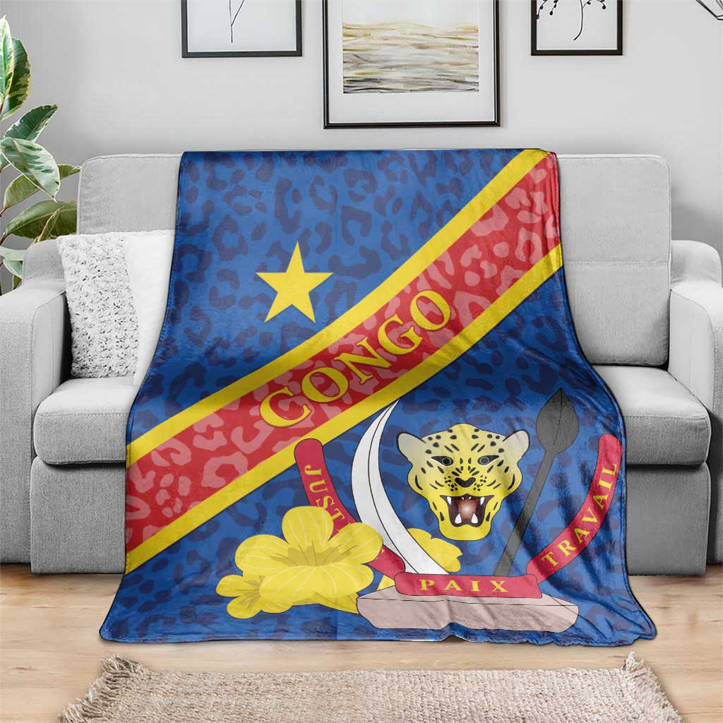 Blue decorative blanket with leopard emblem, yellow star center, and red diagonal accent