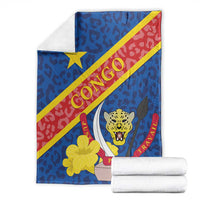 Blue blanket with Congo-style coat of arms, leopard face, yellow star, red diagonal stripe