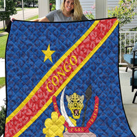 Blue quilt blanket with Congo flag diagonal stripe, leopard emblem, and quilted pattern.